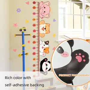 Close-up of PVC growth chart with animal prints and 50-180cm measurement scale