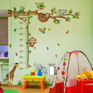 Detail of cartoon animal height chart decal featuring giraffe and elephant on a green wall
