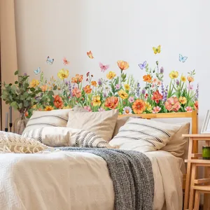 Detail of colorful watercolor floral wall stickers with butterflies on bedroom wall