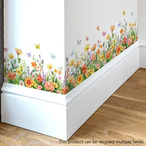 Detailed view of colorful watercolor floral and butterfly wall decals on a white wall