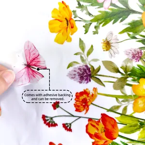 Detail showing removal of a self-adhesive floral and butterfly wall sticker with backing