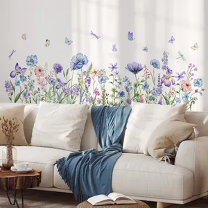 Detailed view of floral wall decals featuring blue iris flowers and butterflies in a living room