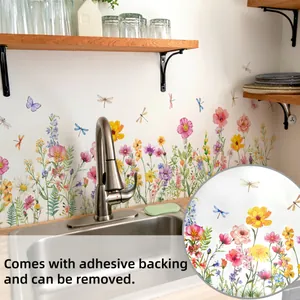 Detail of self-adhesive floral and dragonfly wall decals applied on a kitchen backsplash