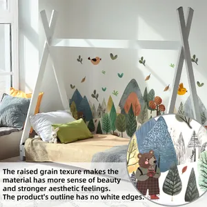 Detail of forest wall sticker with bear and mountain icons on a textured surface