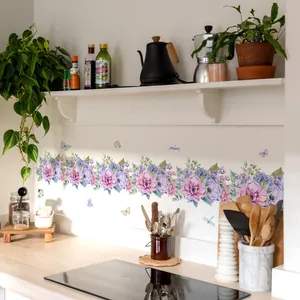 Detail of floral wall stickers with butterflies applied to a modern kitchen backsplash