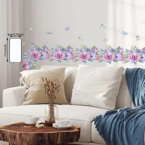 Detail of floral vine wall stickers with butterfly accents in a modern living room setup