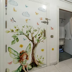 Watercolor fairy and green tree wall stickers applied to a white door for room decoration