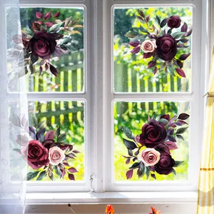 Detail of floral static window clings showing hand-painted watercolor rose patterns on glass
