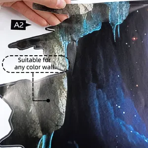 Detailed view of A2 size broken wall space galaxy wall sticker held by hand on white background