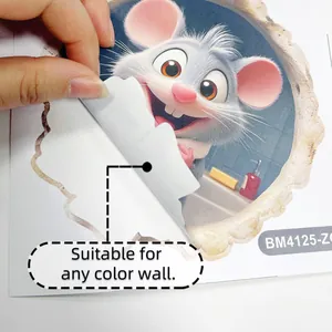 Detail of 3D mouse wall decal being peeled by hand to show adhesive backing