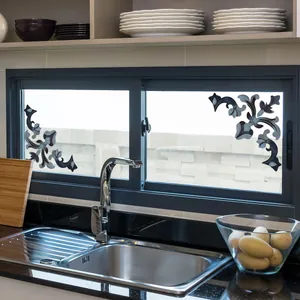 Close-up of black European vine window stickers on kitchen glass with floral design