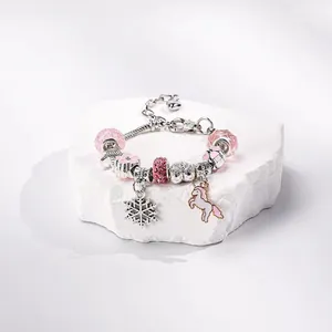 Bracciale natalizio rosa e argento con ciondoli a fiocco di neve e unicorno su pietra