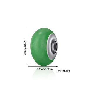 Detail view of a green resin bead with silver core, showing 1.29cm height dimensions