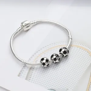 Silver snake chain bracelet with three black and white enamel soccer ball charms