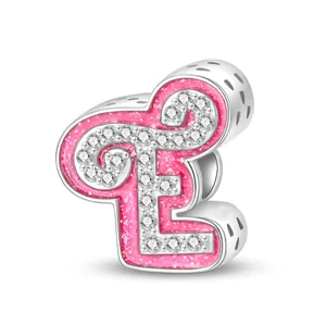 Detail of pink glitter enamel letter E charm with zircons and heart cut-outs