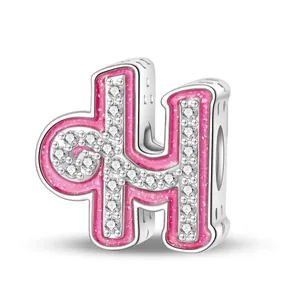 Detailed macro view of silver pink enamel letter H charm bead with sparkling zircons