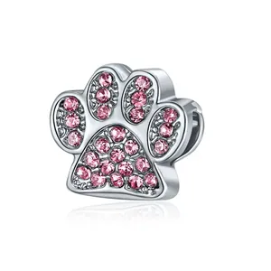 Detailed view of silver alloy paw bead charm set with sparkling pink rhinestones
