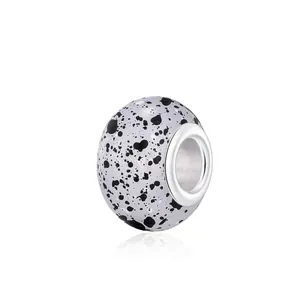 DIY charm bead for bracelets featuring a purple ink marble pattern and silver core