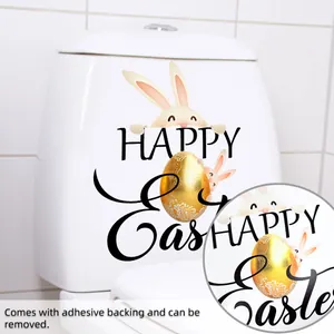 Détail d'autocollants lapin de Pâques et œuf doré sur abattant avec texte Happy Easter