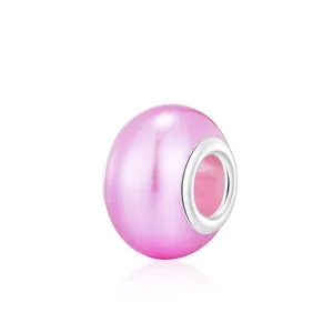 Pink crystal glass bead charm with silver core for DIY bracelet making on white background
