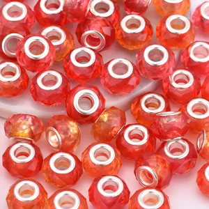 Gros plan de perles en cristal facetté dégradé rouge et orange avec noyau en métal argent