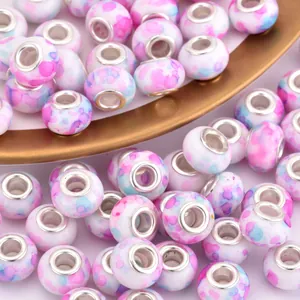 Macro shot of colorful tie-dye resin large hole beads with silver metal core inserts