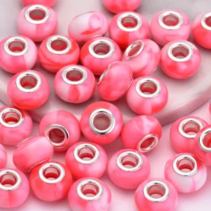 Close-up of pink and white marble resin large hole beads for DIY bracelet jewelry making
