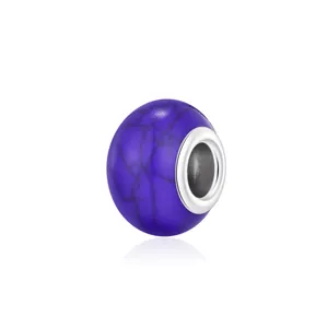 Purple faux turquoise bead with black crackle patterns and silver metal core charm