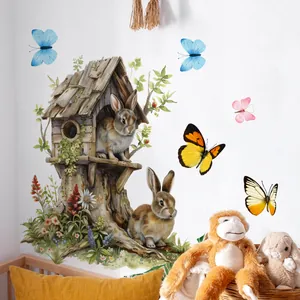 Détails de stickers muraux aquarelle lapins et cabane dans une chambre d'enfant douillette