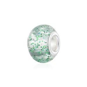 Light green tie-dye resin charm bead with internal green glitter and metal core