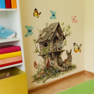 Détail du sticker mural cabane de lapin avec papillons colorés et fleurs sauvages vives