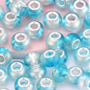 Macro detail of gradient blue acrylic large hole beads with silver metal core inserts