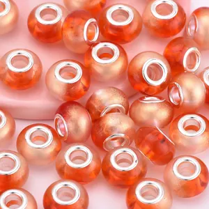 Macro shot of orange gradient resin large hole bead with silver metal core insert