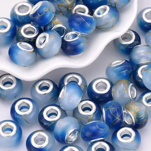 Macro shot of blue gradient acrylic large hole beads with golden streaks and silver core