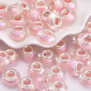 Detailansicht von facettierten rosa Glasperlen mit Polarlicht-Glanz und Silberkern