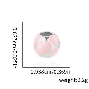 Macro shot showing dimensions of pink heart enamel charm for DIY bracelets