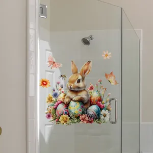 Autocollants de Pâques avec lapin et fleurs sur une porte de salle de bain en verre