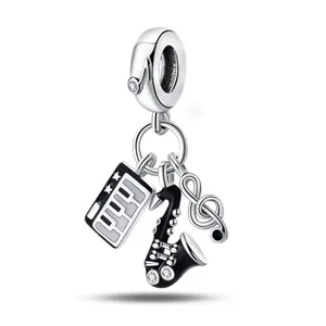 Silver music theme charm with saxophone, piano keys and treble clef pendant