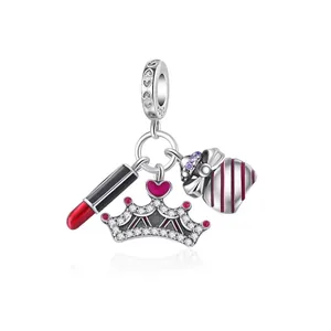 Detailed view of S925 silver charms featuring a red lipstick, crown and handbag