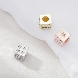 Sparkling star dice charms in gold, silver, and rose gold with inlaid rhinestones