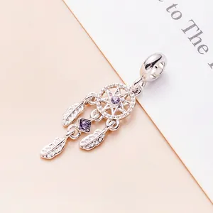 Silver dreamcatcher charm with purple cubic zirconia and delicate feather pendants