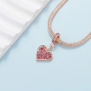 Rose gold snake chain bracelet with heart pendant featuring pink gradient crystals
