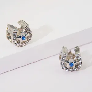 Sparkling horseshoe charm with blue crystal and pave cubic zirconia stars in S925 silver