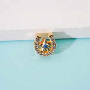 Golden horseshoe star pendant with sparkling rhinestones and blue center gemstone