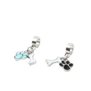 Detailed macro shot of alloy pet paw and bone charms for DIY jewelry bracelets