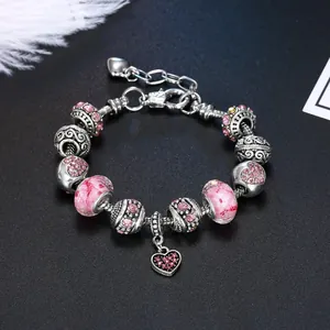 Pink acrylic charms and heart pendant on silver-plated bracelet with crystals