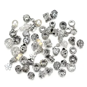 Detailed close-up of retro silver alloy charms with intricate heart and floral patterns