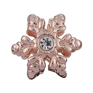 Rose gold snowflake charm with central zircon crystal for DIY bracelets on white background
