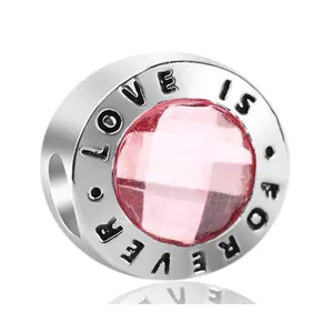 Silver charm with pink faceted gemstone and Love Is Forever engraving for DIY bracelets