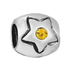 Silver bead charm with embossed star design and a central yellow crystal for DIY jewelry